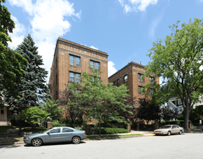 New London apartment for rent - the facade of a brick building with cars parked in front of it