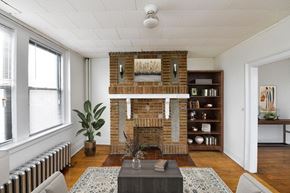 New London apartment for rent - the living room has a brick fireplace and a coffee table