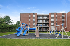 Bristol apartment for rent - a playground in front of a building with slides and swings