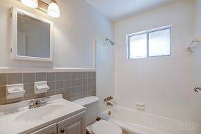 Decatur apartment for rent - A white bathroom with a sink, toilet, and bathtub.