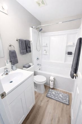 Cincinnati apartment for rent - A white bathroom with a toilet, sink, and shower.