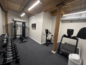 Nashua apartment for rent - A gym with a row of dumbbells on the left and a treadmill on the right.