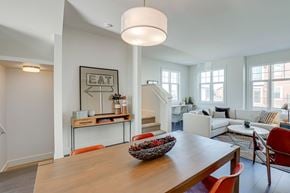 Saskatoon apartment for rent - A modern dining room with a wooden table and chairs.