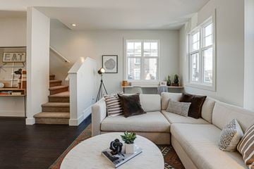 Saskatoon apartment for rent - A living room with a white couch and a coffee table.