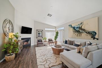 Pittsburg apartment for rent - A living room with a fireplace, a couch, and a painting on the wall.