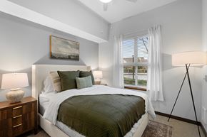 Hillsboro apartment for rent - A bedroom with a bed, nightstand, and a painting on the wall.