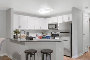 Hillsboro apartment for rent - A kitchen with white cabinets and a grey counter.