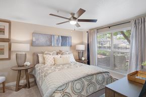 Hillsboro apartment for rent - A bedroom with a large bed and a ceiling fan.