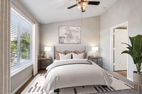 Petaluma apartment for rent - A bedroom with a large bed and a ceiling fan.