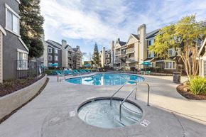 Livermore apartment for rent - A hot tub sits in the middle of a pool surrounded by apartment buildings.