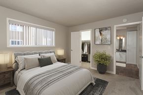 Cupertino apartment for rent - A bedroom with a large bed and a potted plant.