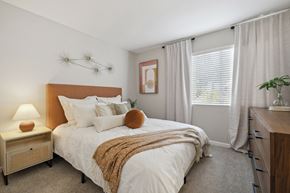 Simi Valley apartment for rent - A bedroom with a bed, nightstand, and window.