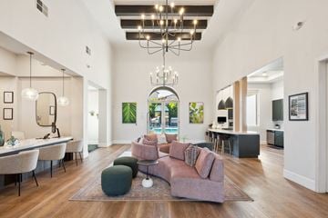 Roseville apartment for rent - A living room with a large couch and a chandelier.