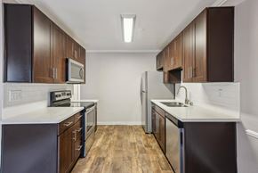 Campbell apartment for rent - A kitchen with dark wood cabinets and stainless steel appliances.
