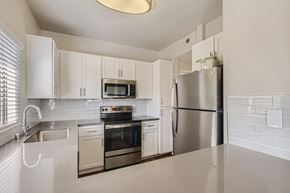 Laguna Niguel apartment for rent - A kitchen with white cabinets and appliances.