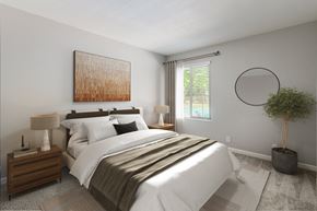 Walnut Creek apartment for rent - A bedroom with a large bed, a nightstand with a lamp, a plant, and a painting on the wall.