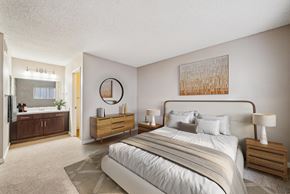 Campbell apartment for rent - A bedroom with a large bed, nightstands, and a painting on the wall.