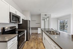 Antioch apartment for rent - A modern kitchen with white cabinets and stainless steel appliances.