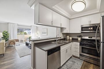 Simi Valley apartment for rent - A modern kitchen with stainless steel appliances and white cabinets.