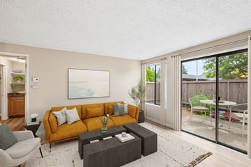 Vancouver apartment for rent - A living room with a yellow couch and a painting on the wall.