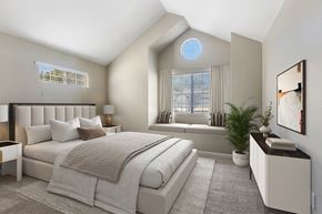 Sacramento apartment for rent - A bedroom with a large bed and a window with blinds.