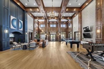 Reno apartment for rent - A spacious living room with a pool table and a fireplace.