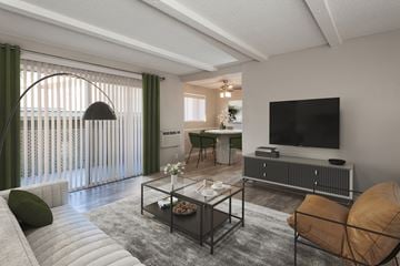 Cupertino apartment for rent - A modern living room with a glass coffee table and a flat screen TV.