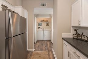 Sacramento apartment for rent - A kitchen with a stainless steel refrigerator and white cabinets.