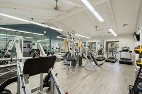 Vacaville apartment for rent - A gym with a variety of equipment including treadmills, weights, and exercise machines.