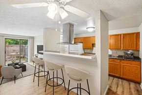 Vancouver apartment for rent - A kitchen with a white ceiling fan and a white counter top.