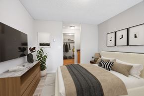 Vancouver apartment for rent - A bedroom with a large bed and a TV on the wall.