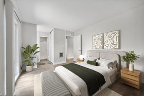 Alameda apartment for rent - A bedroom with a large bed and a plant on the nightstand.
