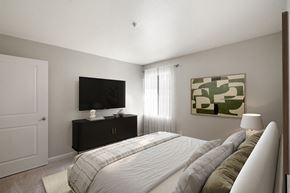 Livermore apartment for rent - A bedroom with a bed, a television, and a painting on the wall.