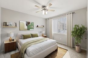 Antioch apartment for rent - A bedroom with a bed, nightstand, and a plant.
