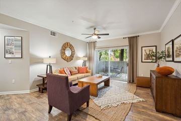 Vacaville apartment for rent - A living room with a purple chair and a wooden coffee table.