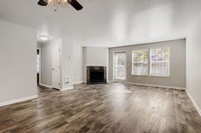 Vancouver apartment for rent - A spacious living room with a fireplace and wood flooring.