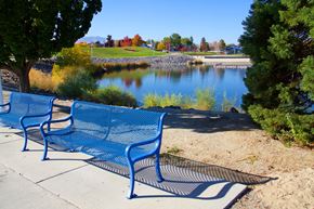 Sparks apartment for rent - two blue benches overlooking a lake at a park