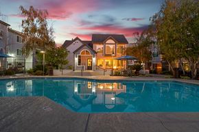 Rancho Cordova apartment for rent - a swimming pool at dusk with a house in the background