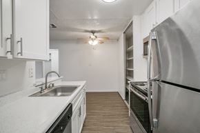 Concord apartment for rent - A kitchen with white cabinets and a stainless steel refrigerator.