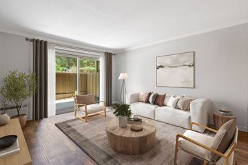 Walnut Creek apartment for rent - A living room with a couch, chair, and a table with a plant on it.