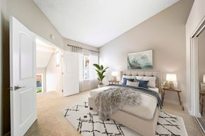 Alta Loma apartment for rent - A bedroom with a large bed and a painting on the wall.