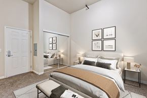 Fairfield apartment for rent - A bedroom with a large bed and a mirror on the wall.
