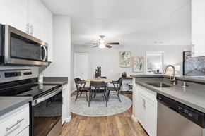 Rocklin apartment for rent - A modern kitchen with a dining table and chairs in the middle.