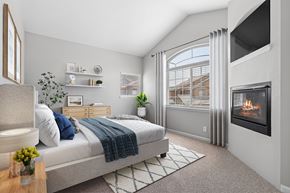 Greenwood Village apartment for rent - A bedroom with a large bed and a fireplace.