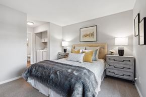 Rocklin apartment for rent - A bedroom with a bed, nightstands, and a painting on the wall.