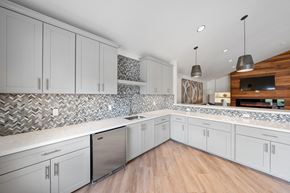 Alameda apartment for rent - A kitchen with white cabinets and a wooden counter.