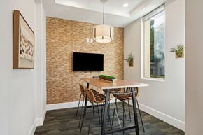Roseville apartment for rent - A dining room with a brick wall and a flat screen TV.