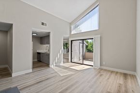 Roseville apartment for rent - an open living room and kitchen with a sliding glass door to a patio