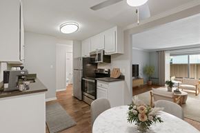 Walnut Creek apartment for rent - A modern kitchen with a dining table set with flowers in the middle.