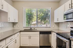 Aliso Viejo apartment for rent - a kitchen with white cabinets and a window